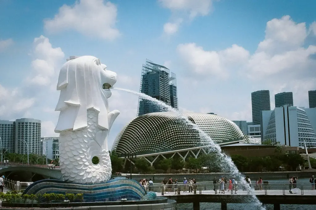 Merlion Park in Singapore featuring the iconic Merlion statue overlooking Marina Bay with the Esplanade and Singapore skyline in the background.