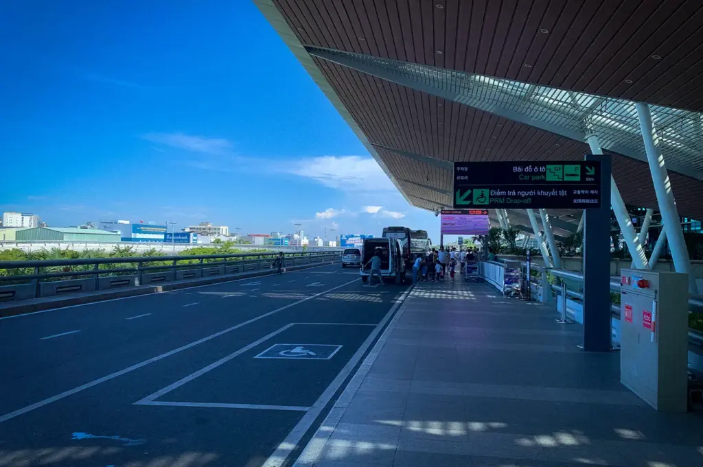 Exterior passenger drop-off area and modern terminal canopy at Da Nang International Airport in Vietnam