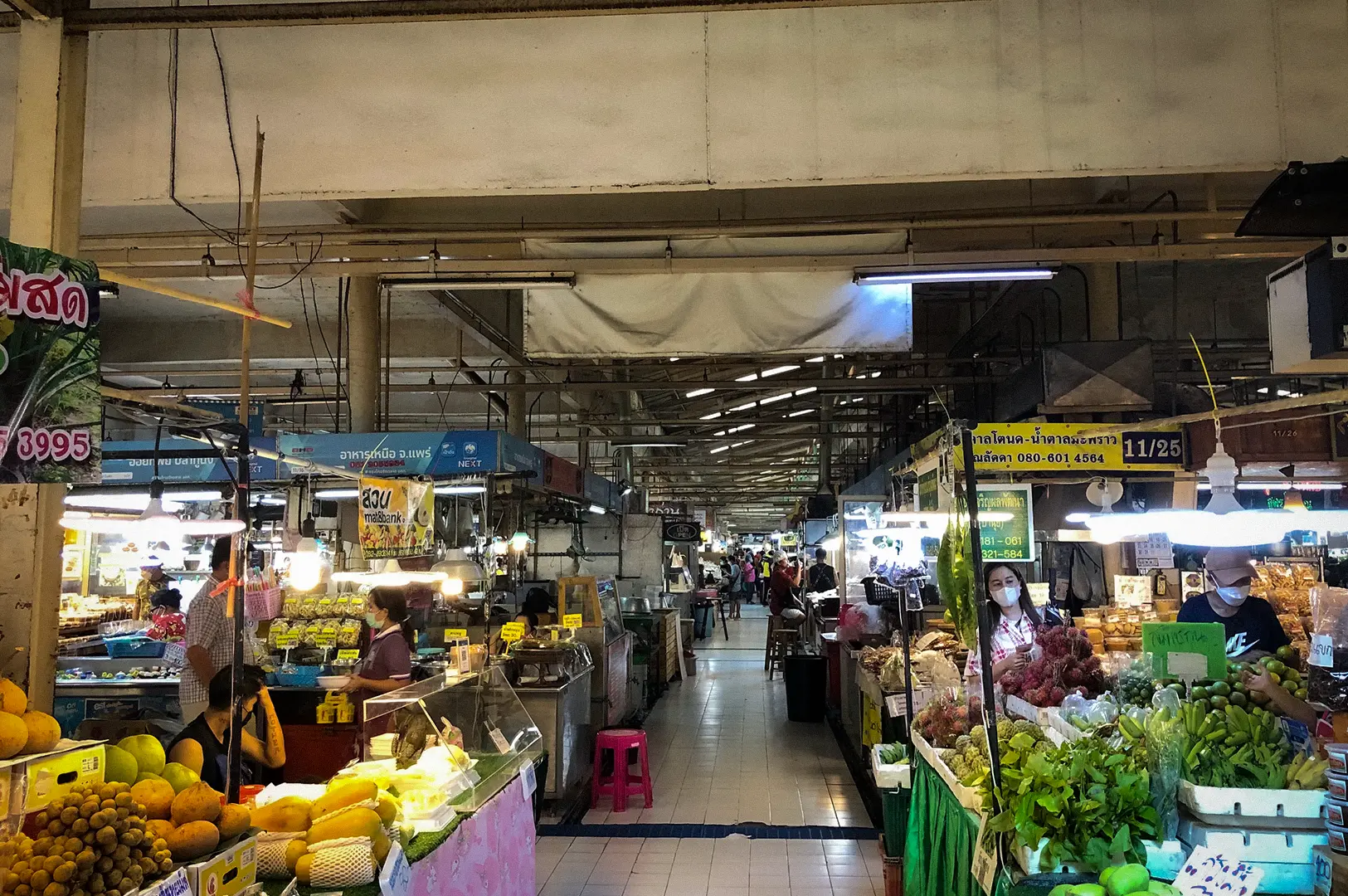 Or Tor Kor Market Bangkok with fresh fruits, vegetables, food stalls, and local vendors inside the covered market