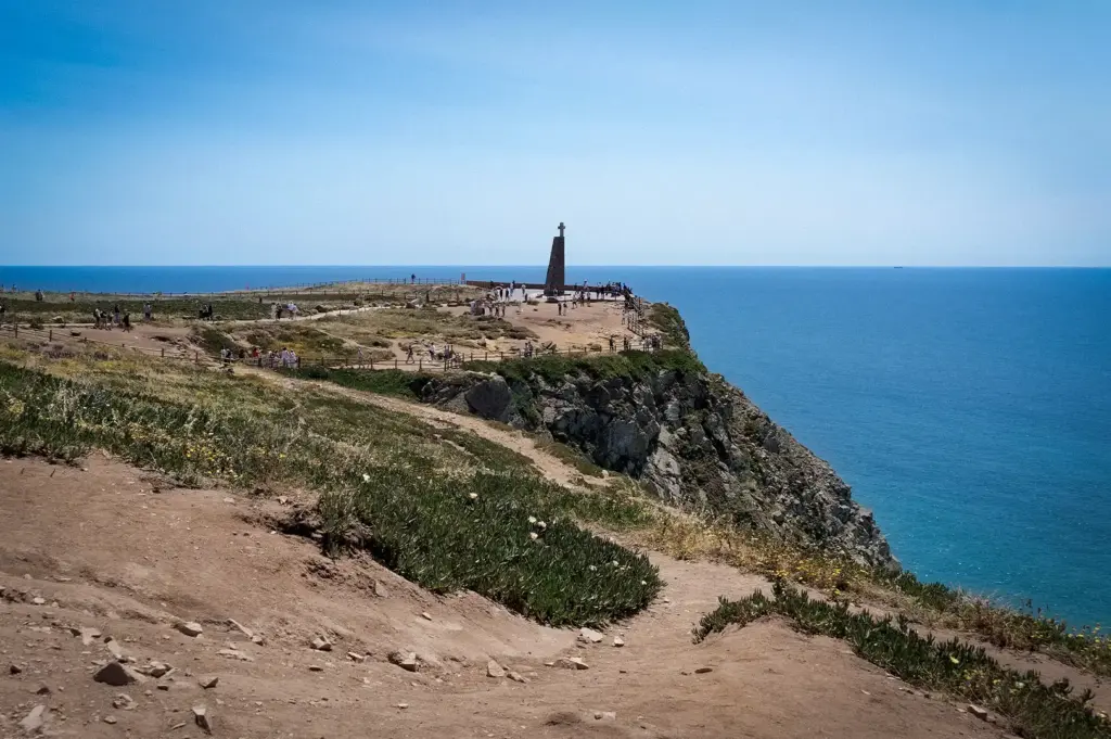 Scenic view of the monument and rugged coastal cliffs at Cabo da Roca, the westernmost point of mainland Europe, overlooking the Atlantic Ocean in Portugal